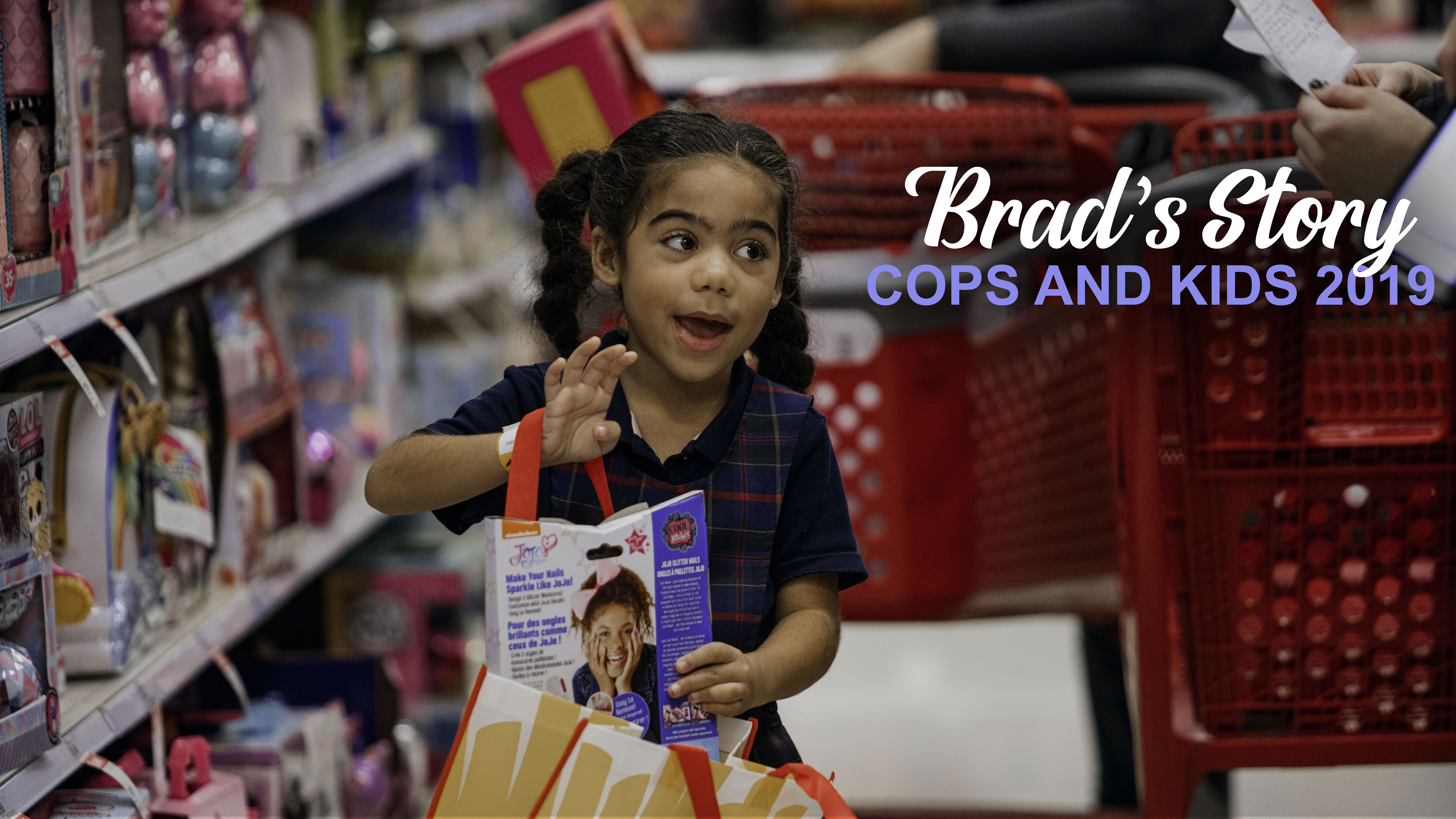 Young girl adding a toy to her bag at KC FOP KCPD Cops and Kids event. Reads "Brad's Story: Cops and Kids 2019"