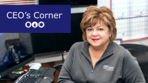 Mary Shea sitting at her computer and smiling at camera. Reads "CEO's Corner"