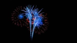 Red and blue fireworks against a jet black sky